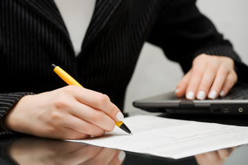 Businesswoman signing the contract.