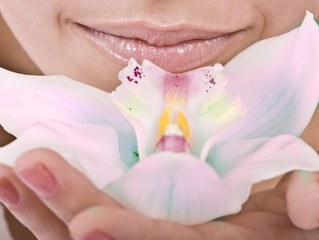 Female lips and orchid flower. Spa.