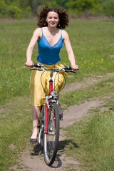 Fototapeta na wymiar girl goes by bicycle