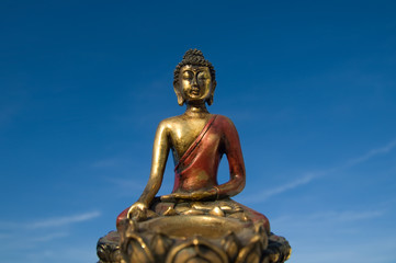 Fototapeta premium China / Tibet - Buddha in front of blue sky