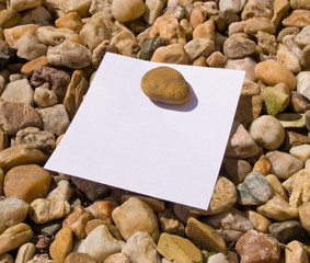 Post-it note isolated on stones