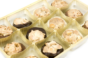 Chocolats in plastic box isolated on white background