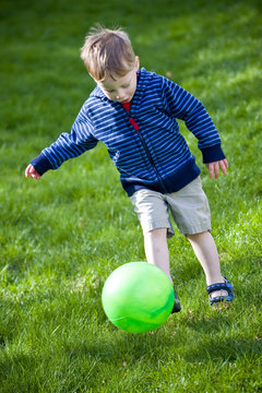 Boy kicking ball