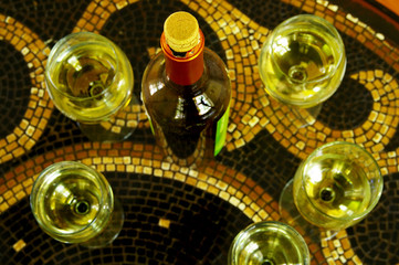assorted glasses of white wine and wine bottle with cork