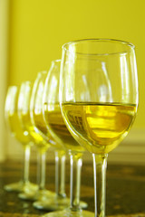 group of white wine glasses in a row