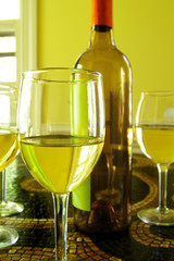 assorted glasses of white wine and bottle