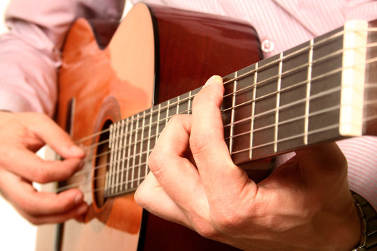 Acoustic guitar player close-up with focus on the hand