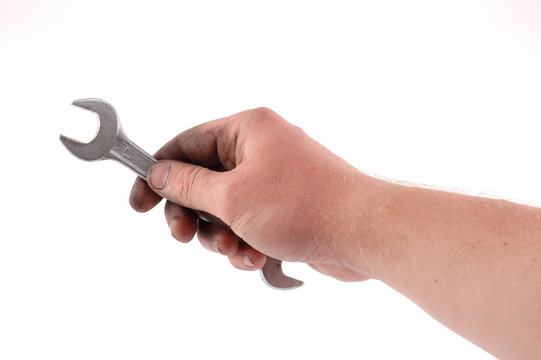 a metallic wrench is in a hand
