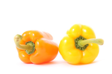 Orange and yellow peppers isolated on white