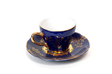 Empty dark blue and gold cup, isolated over white board