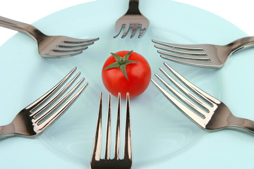 forks and tomat on dish