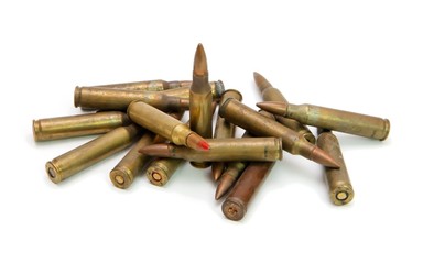Pile of 5.56mm M16 assault rifle cartridges isolated