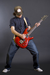 passionate guitarist playing his electric guitar