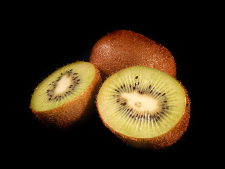 Sliced kiwi on black background