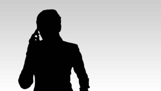 Silhouette of a businesswoman on phone