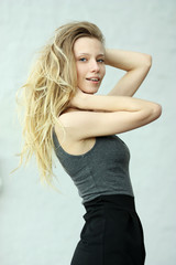 Beautiful woman standing against wall in background