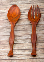 Wooden spoon and fork on vintaged wood background