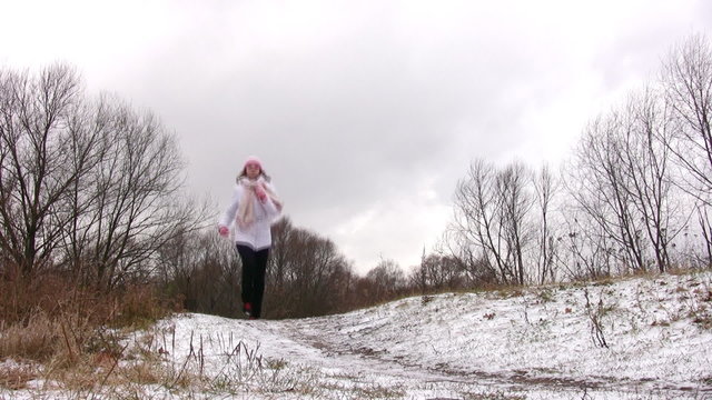 Woman running to camera on first snow way.