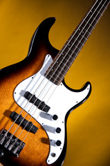 Obraz na płótnie Canvas Sunburst Bass Guitar On Gold