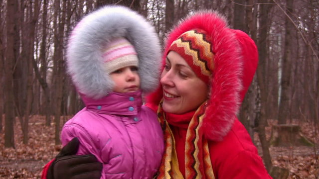 mother with girl in fur clothes
