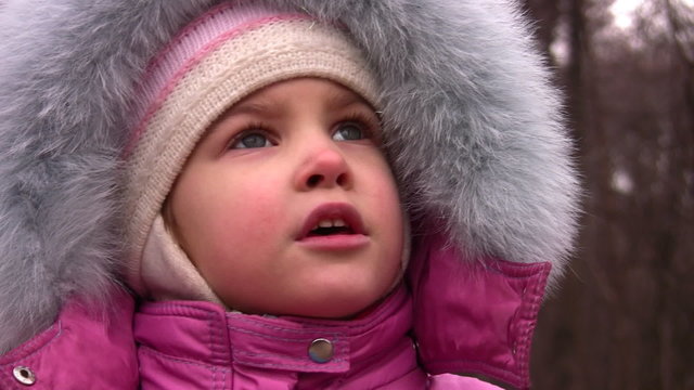 little girl talking in winter park, closeup