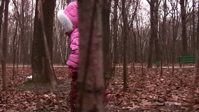 walking little girl in winter park