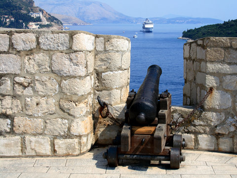 Old cannon and cruise ship in Dubrovnik old town, Croatia.