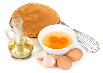 Eggs, oil, pancakes and whisk