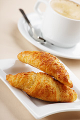 Coffee cup and croissant
