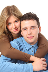 Girl embraces  man for neck behind