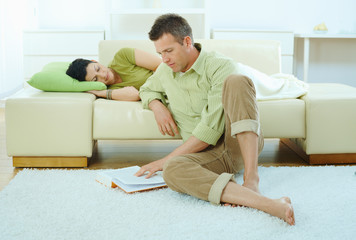 Man reading book at home