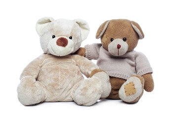 Two Teddy bears hugging each other over white background