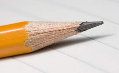 Sharpened lead pencil on notepad