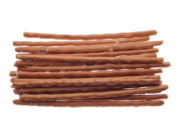 salted baked bread sticks  on white