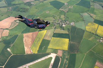 Skydiver flies past cameraman