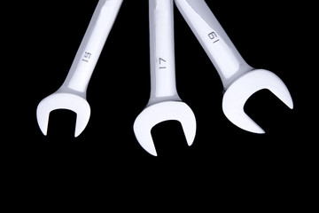three wrenches on black