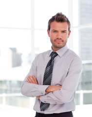 Serious businessman with folded arms