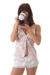 Fototapeta premium Beautiful young woman is drinking her morning coffee
