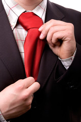 Business man fixing his tie