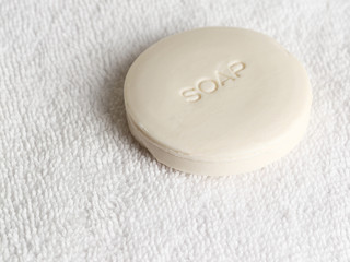 Obraz na płótnie Canvas Piece of soap on a white towel