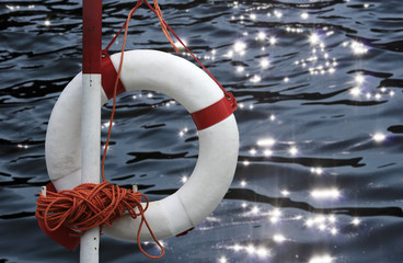 life buoy in front of glittering water