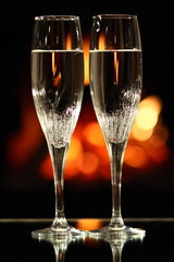 two glasses in front of fireplace