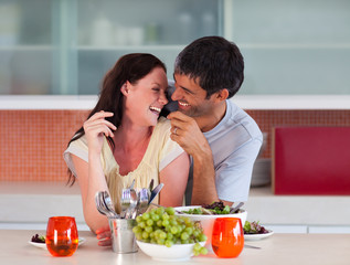 Lovers eating in the kitchen