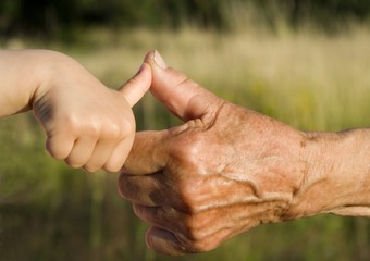 hand of grandmother and grandchild