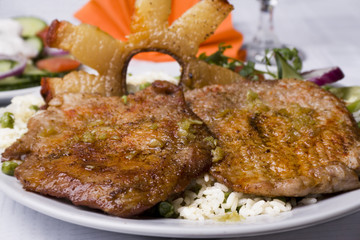 Hungarian lunch with porcine meat and bacon with rice