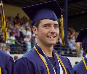 Male high school graduate attending graduation ceremony