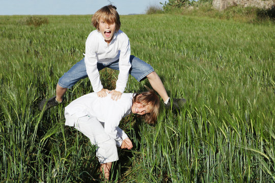 Kids Playing Leapfrog In Summer