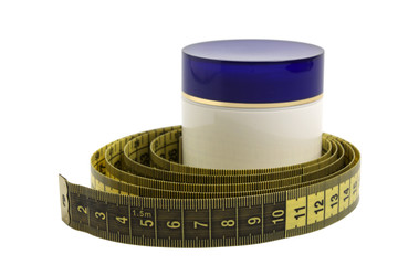 Jar with cosmetic cream and measuring tape