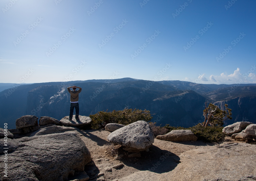 Wall mural Male hiker looking at view from Yosemite Peak