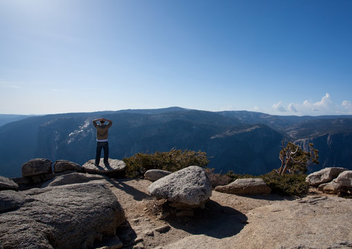 Male hiker looking at view from Yosemite Peak